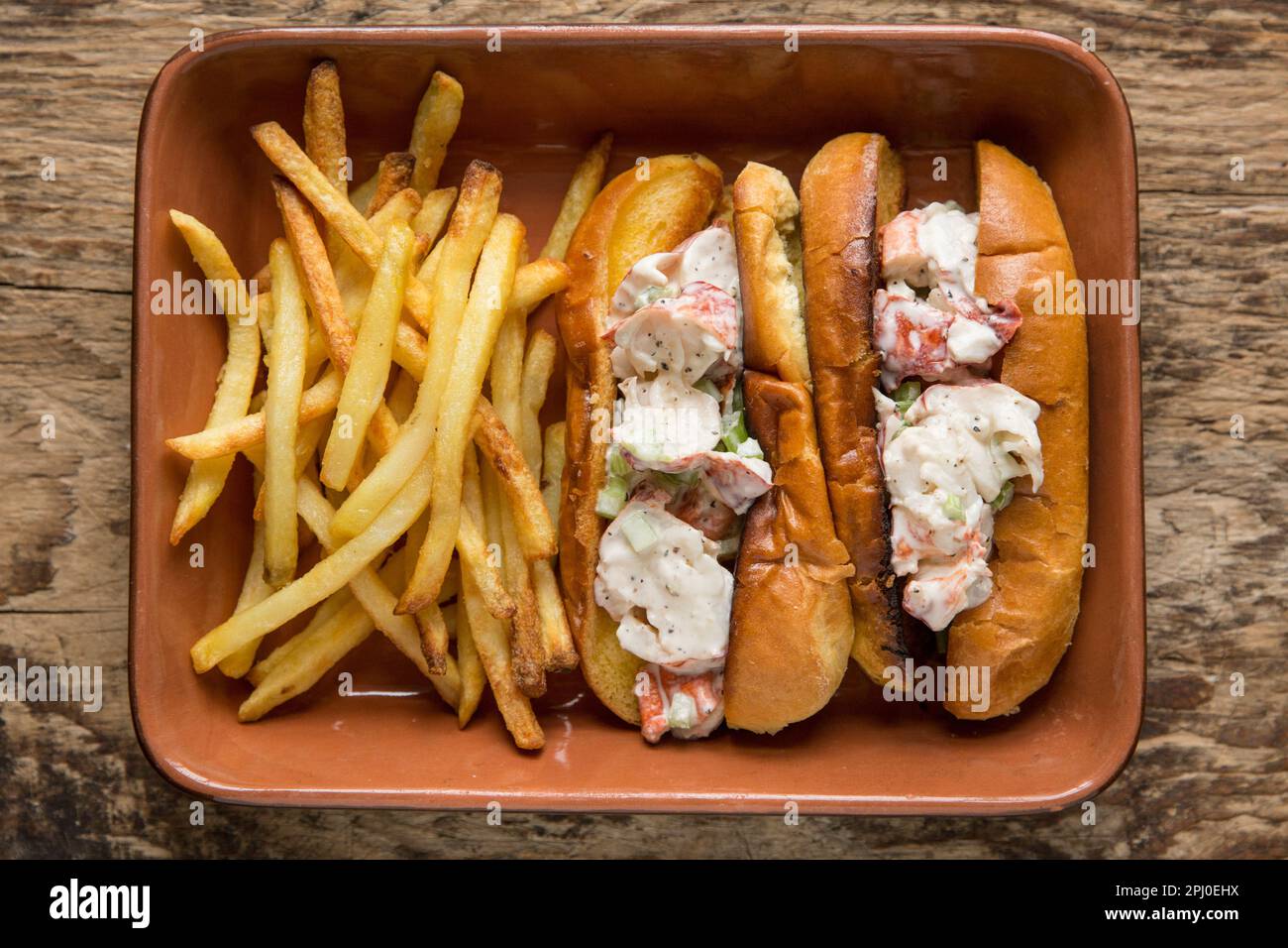 Lobster brioche rolls made with a boiled lobster, Homarus gammarus, caught in the English Channel. The lobster is combined with mayonnaise, diced cele Stock Photo
