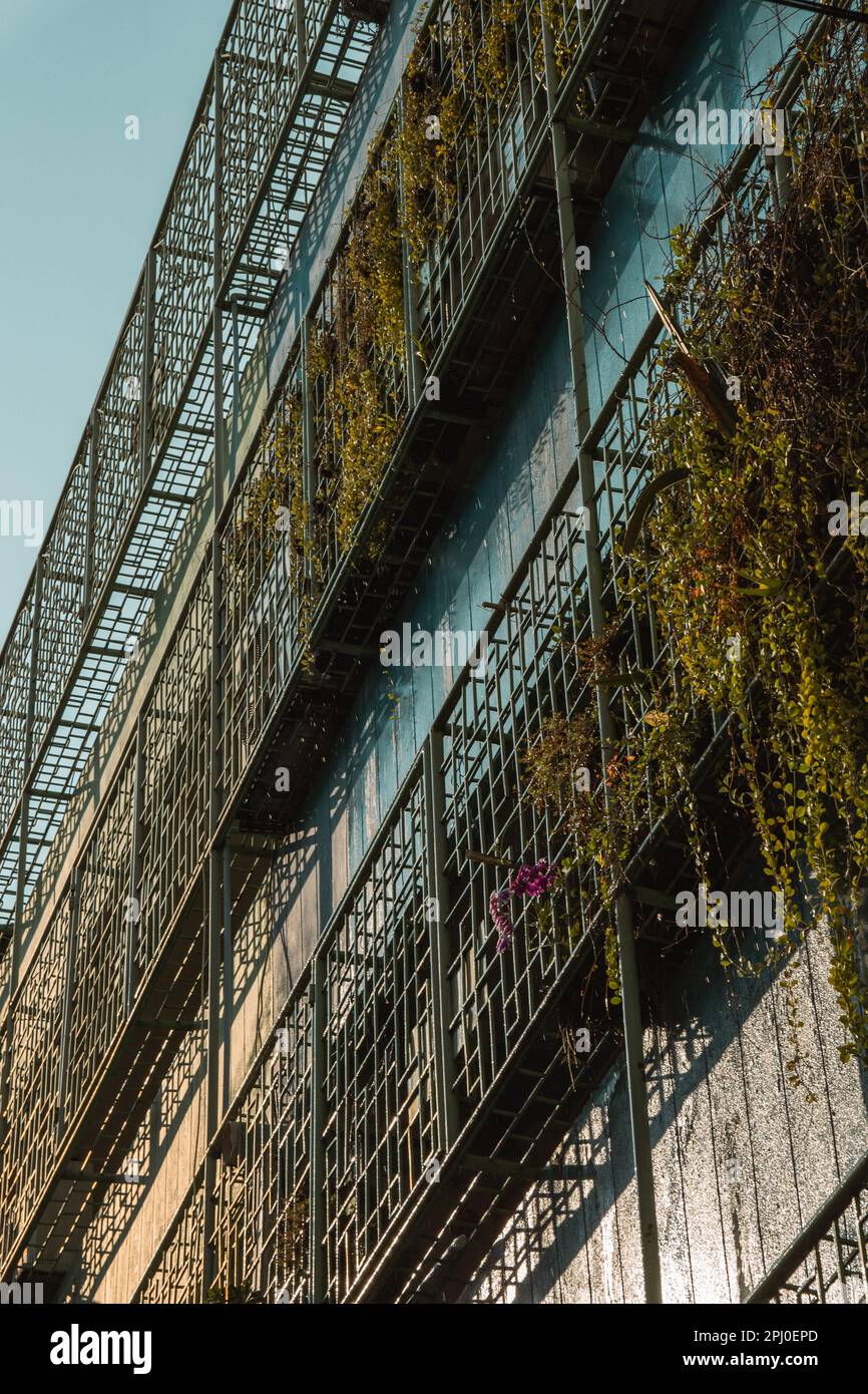 A low angle vertical shot of a building exterior featuring metal ...