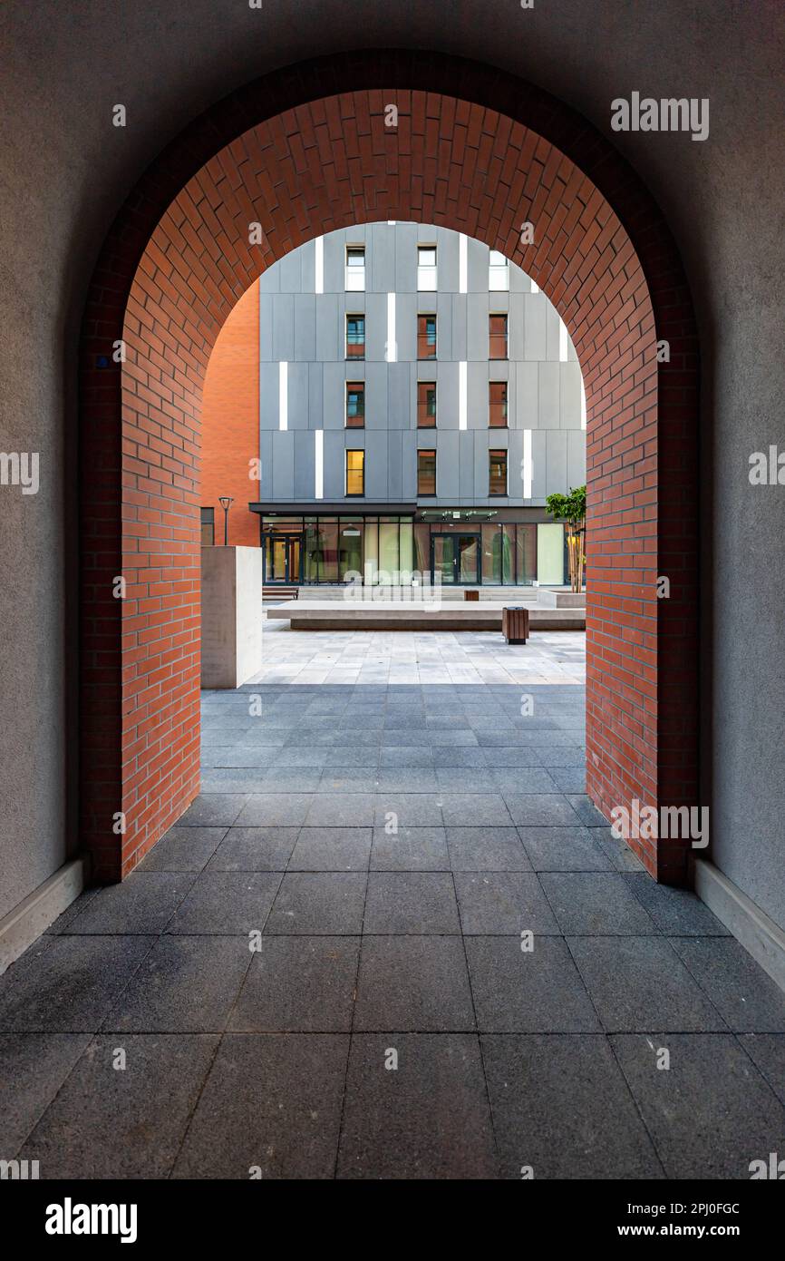 Wroclaw, Poland June 2022 Red brick arch as an entrance to a new