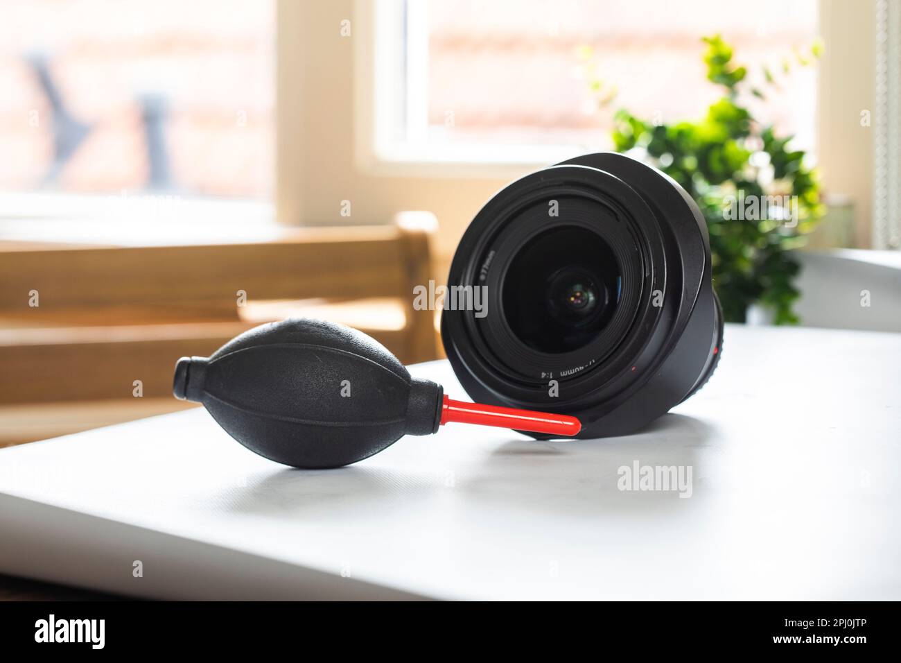 Lens on desk with cleaning tools for DSLR and Mirrorless cameras. Cleaning kit for cmos surface