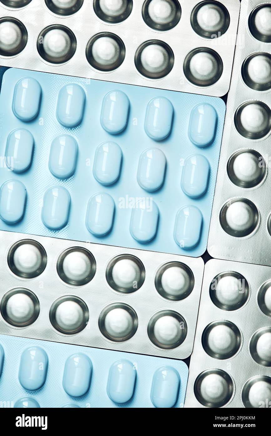 Tablets and capsules pill in blister packaging arranged in row. Medicines tablets, pills in