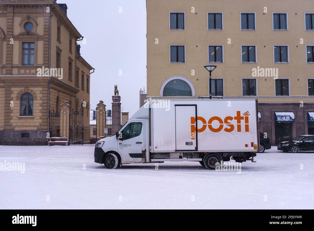 Delivery truck of the Posti group, the main Finnish postal service parked on the street in winter. Hameenlinna, Finland. February 23, 2023. Stock Photo