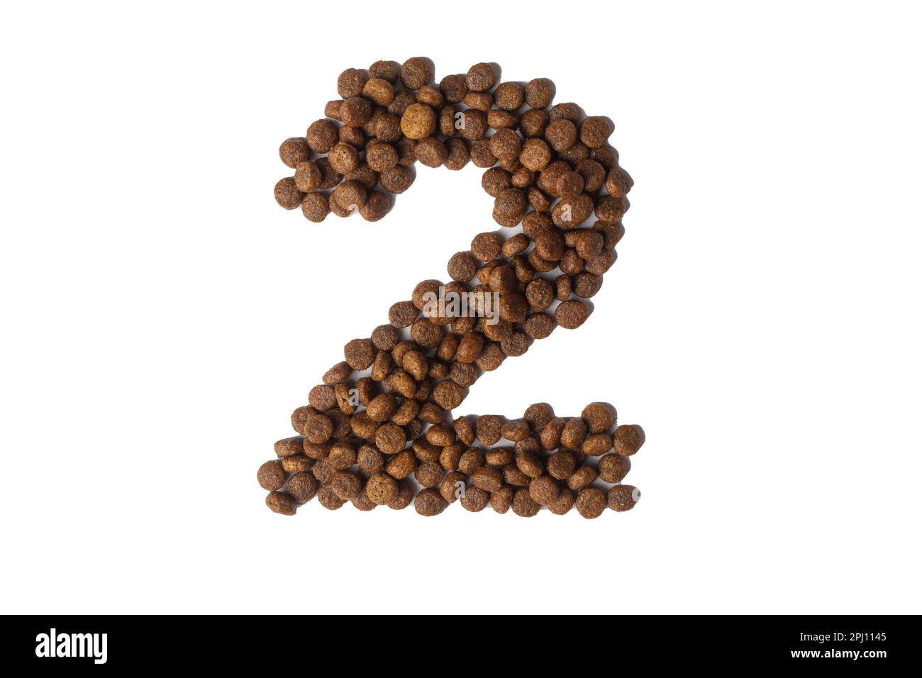 Number 2 made from dry pet food on a white background. Design, layout. Dietary therapeutic nutrition for dogs and cats. Favorite food for animals. Car Stock Photo