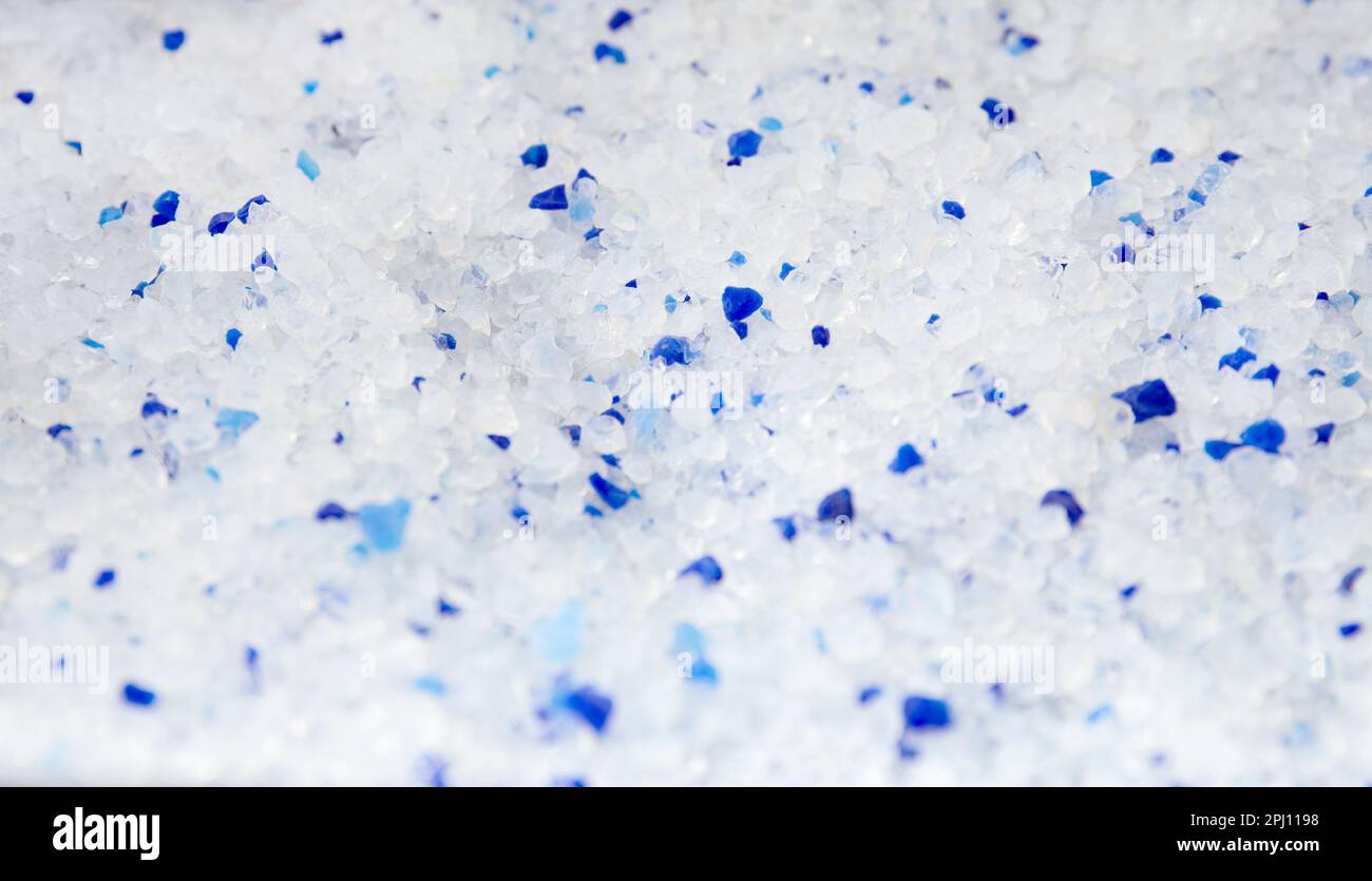 Silica gel white with blue crystals cat litter closeup. Abstract