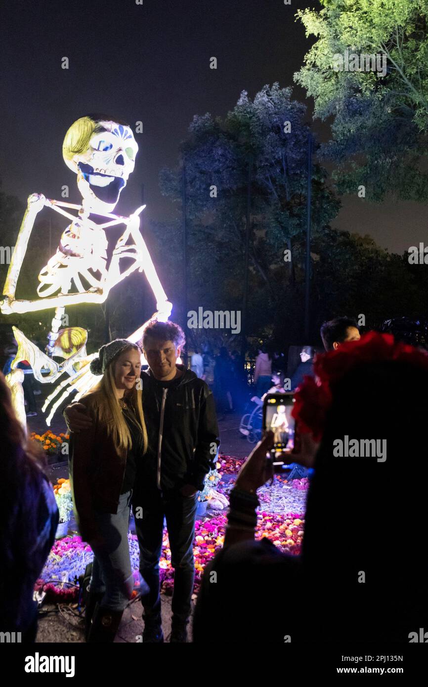 Halloween in Mexico City. People looking at Dia de muertos sculptures
