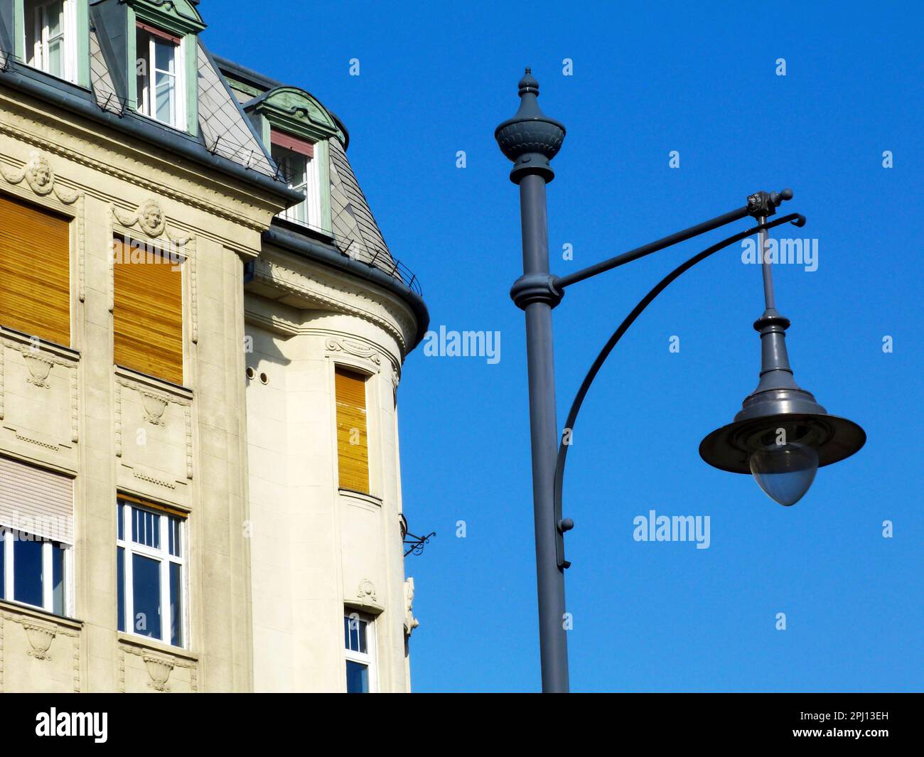 retro style lamppost head. closeup detail. low angle view. stucco