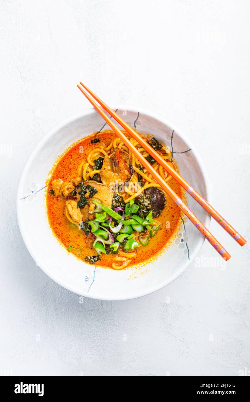 Thai red curry noodle soup with shiitake, coconut milk and green onions