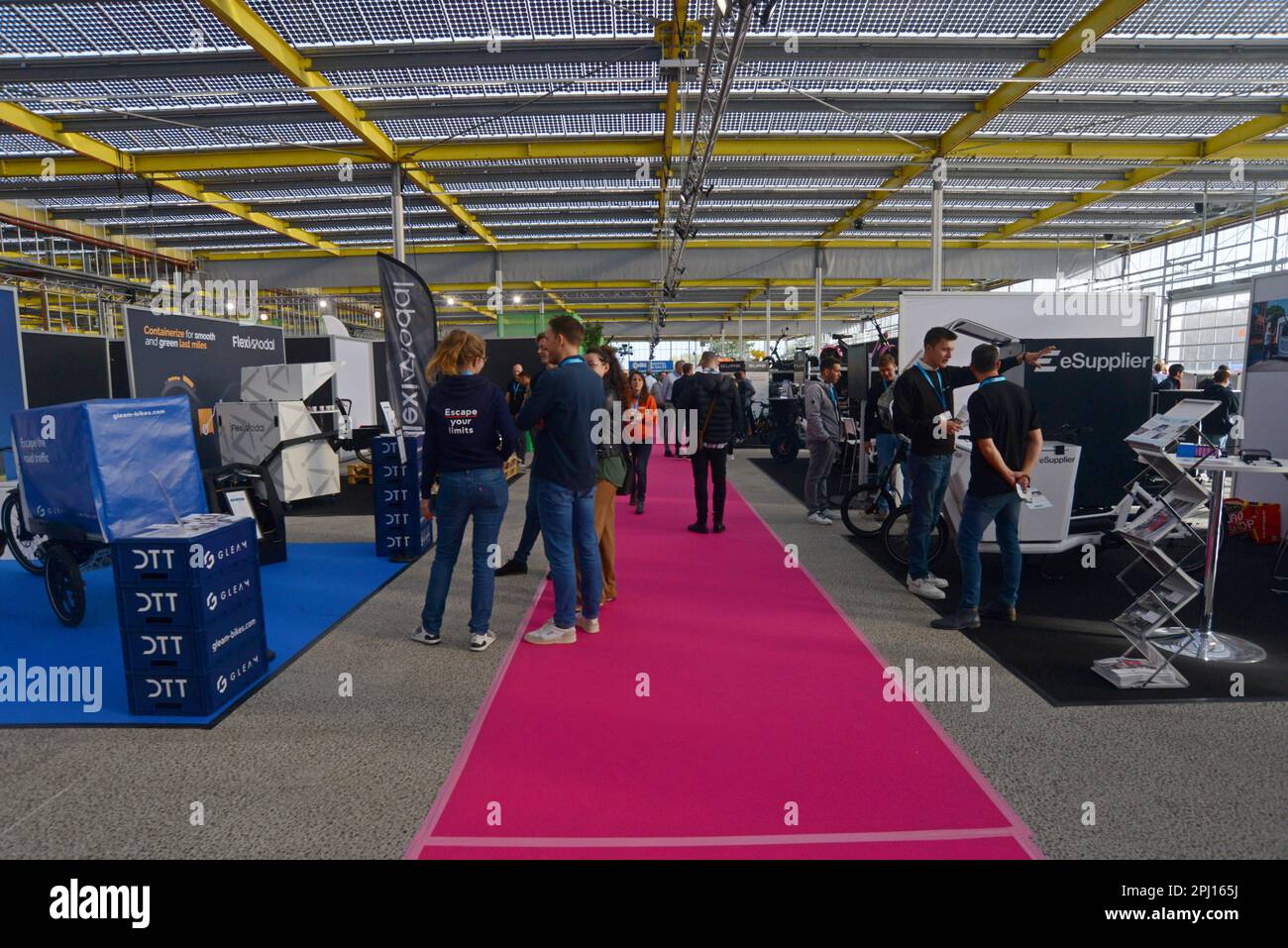 People looking at electric assist cargo bikes and trikes on display at the International Cargo Bike Festival, Haarlem, Netherlands, Nov 2022 Stock Photo