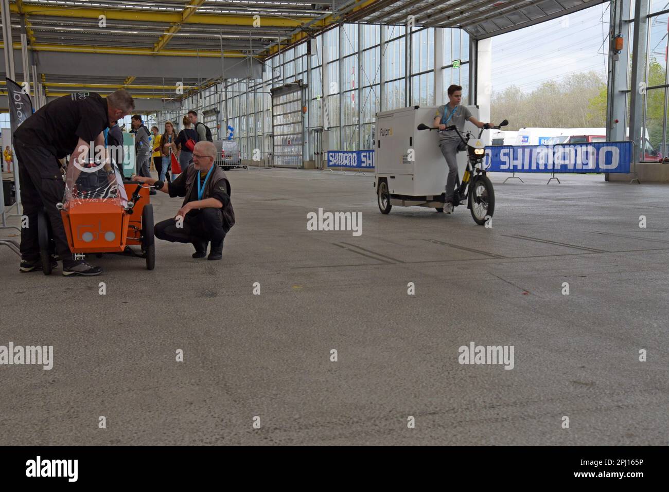 People testing electric assist load carrying bikes on display at the International Cargo Bike Festival, Haarlem, Netherlands, Nov 2022 Stock Photo