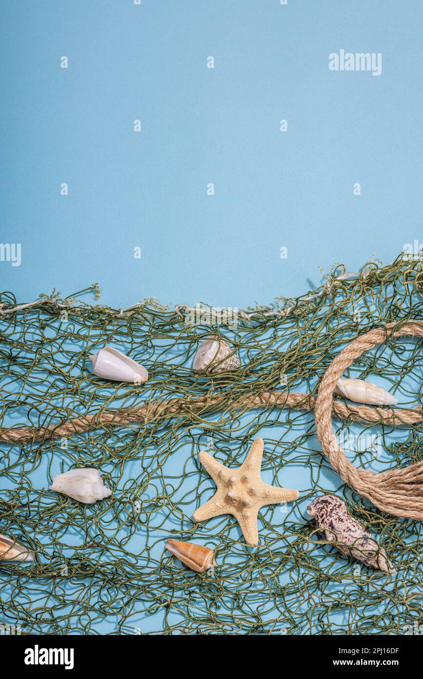 Blue nautical background with sea shells, starfishes and fishing net ...