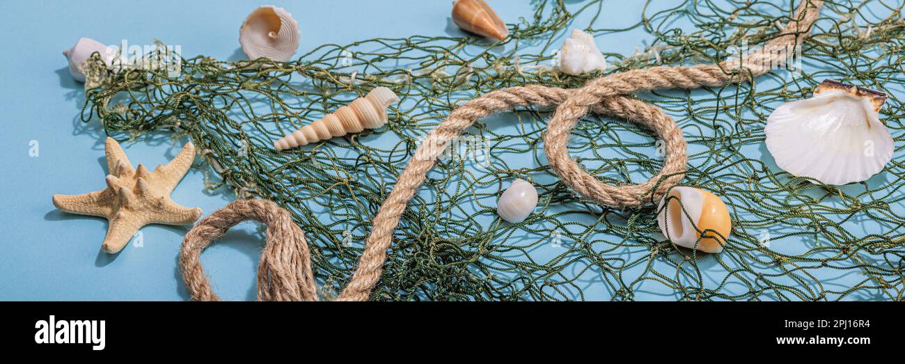 Blue nautical background with sea shells, starfishes and fishing net ...