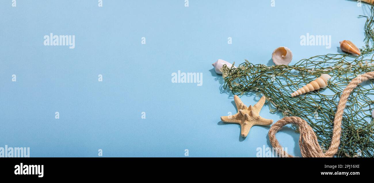 Blue nautical background with sea shells, starfishes and fishing net ...
