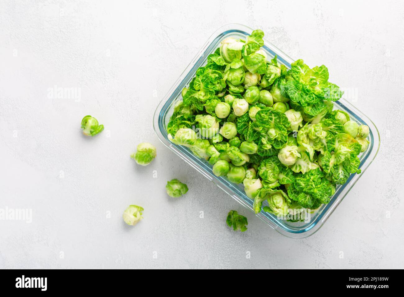 Fresh  organic green brussels sprouts and small winter cabbage vegetable in glass container, ready to freeze Stock Photo