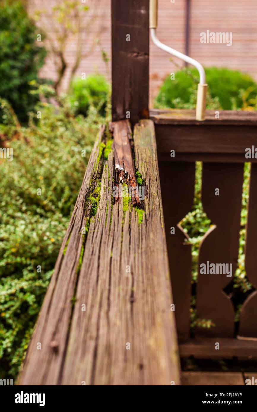 Damege Railing Old wooden terrace, damaged old wooden railing in a garden, weather ...