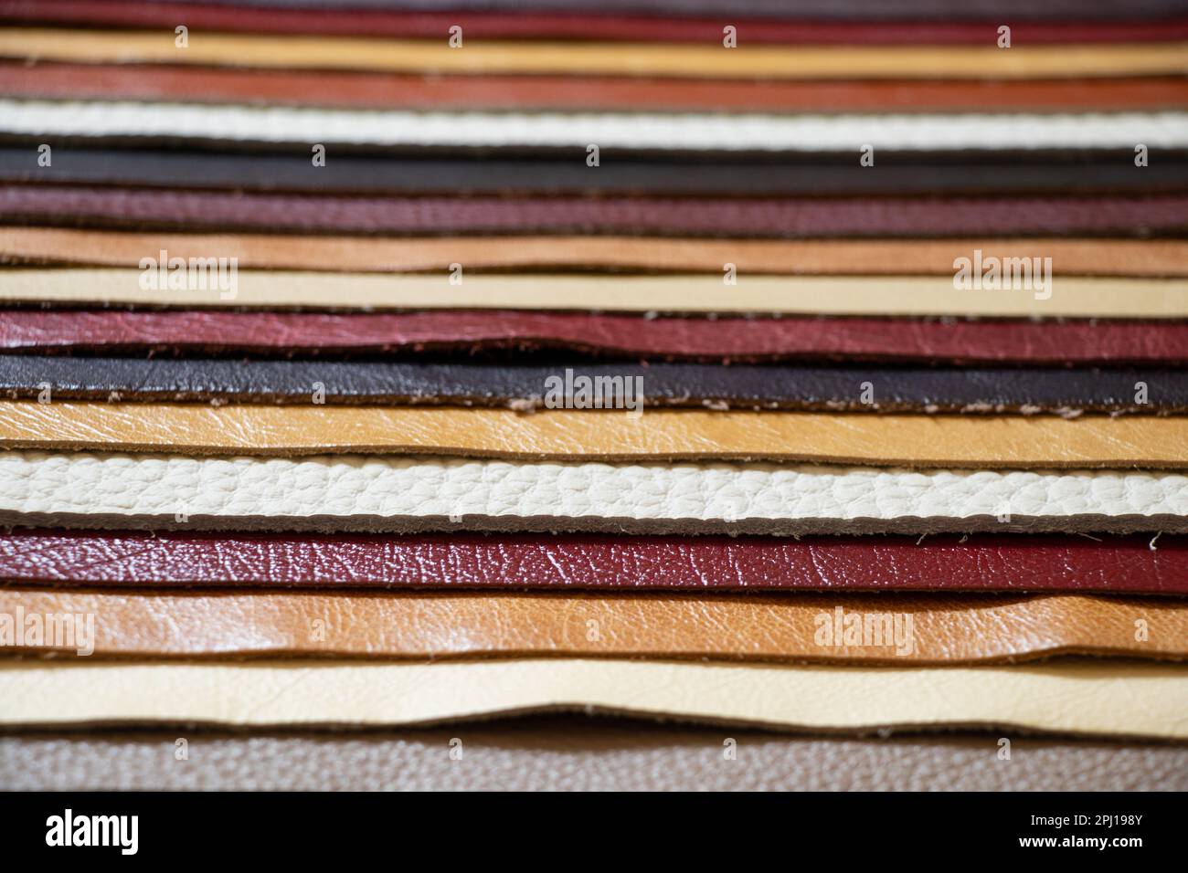 different colors pieces of leather as a background closeup Stock Photo