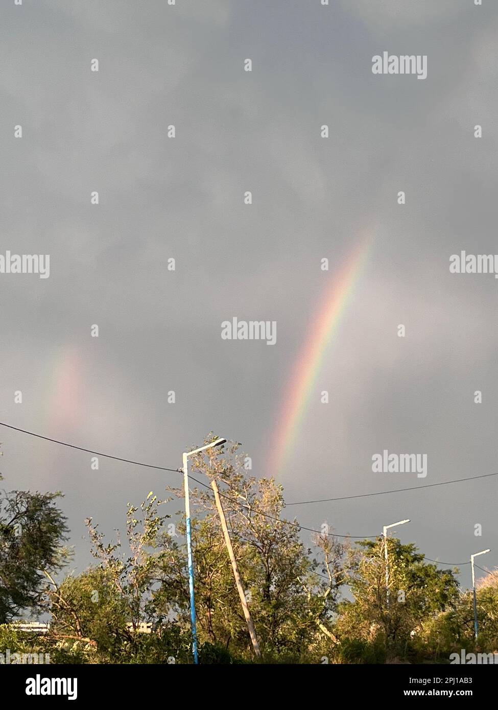 colorful rainbow after summer storm Stock Photo - Alamy