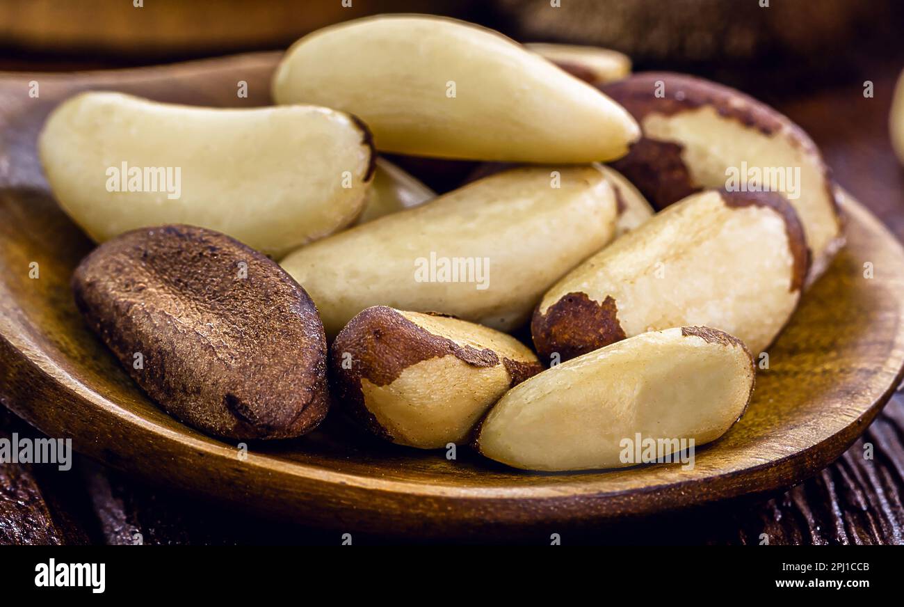 wooden spoon with many unshelled Amazon nuts, also called acre nut