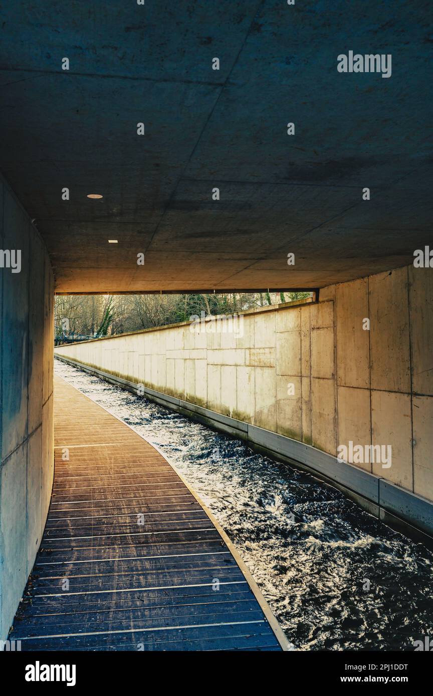 A canal with water leads into a tunnel. Stock Photo