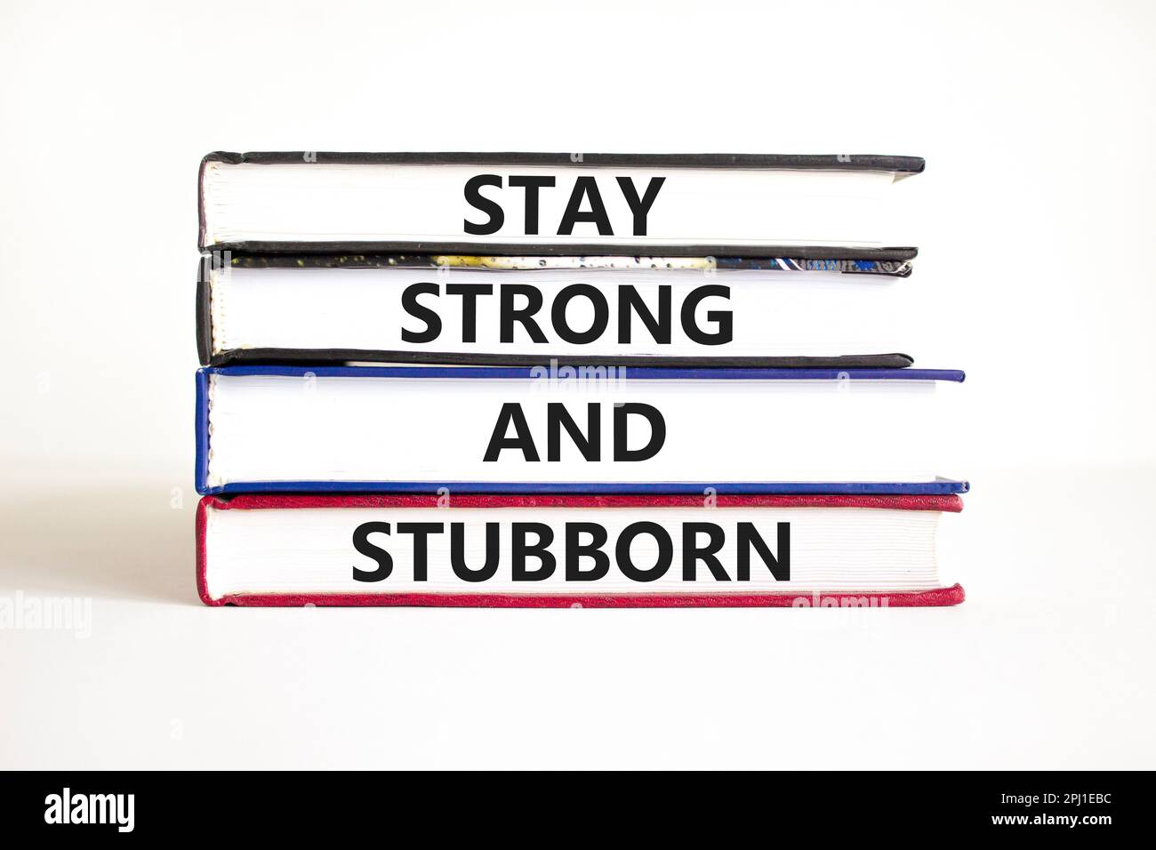 Stay strong and stubborn symbol. Concept words Stay strong and stubborn on books. Beautiful
