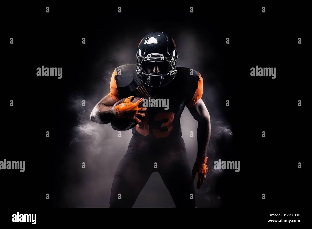 American football player on a dark background in smoke in black and orange equipment Stock Photo