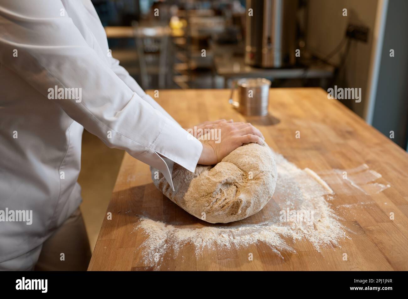 Baking process, closeup baker hands kneading dough on table Stock Photo