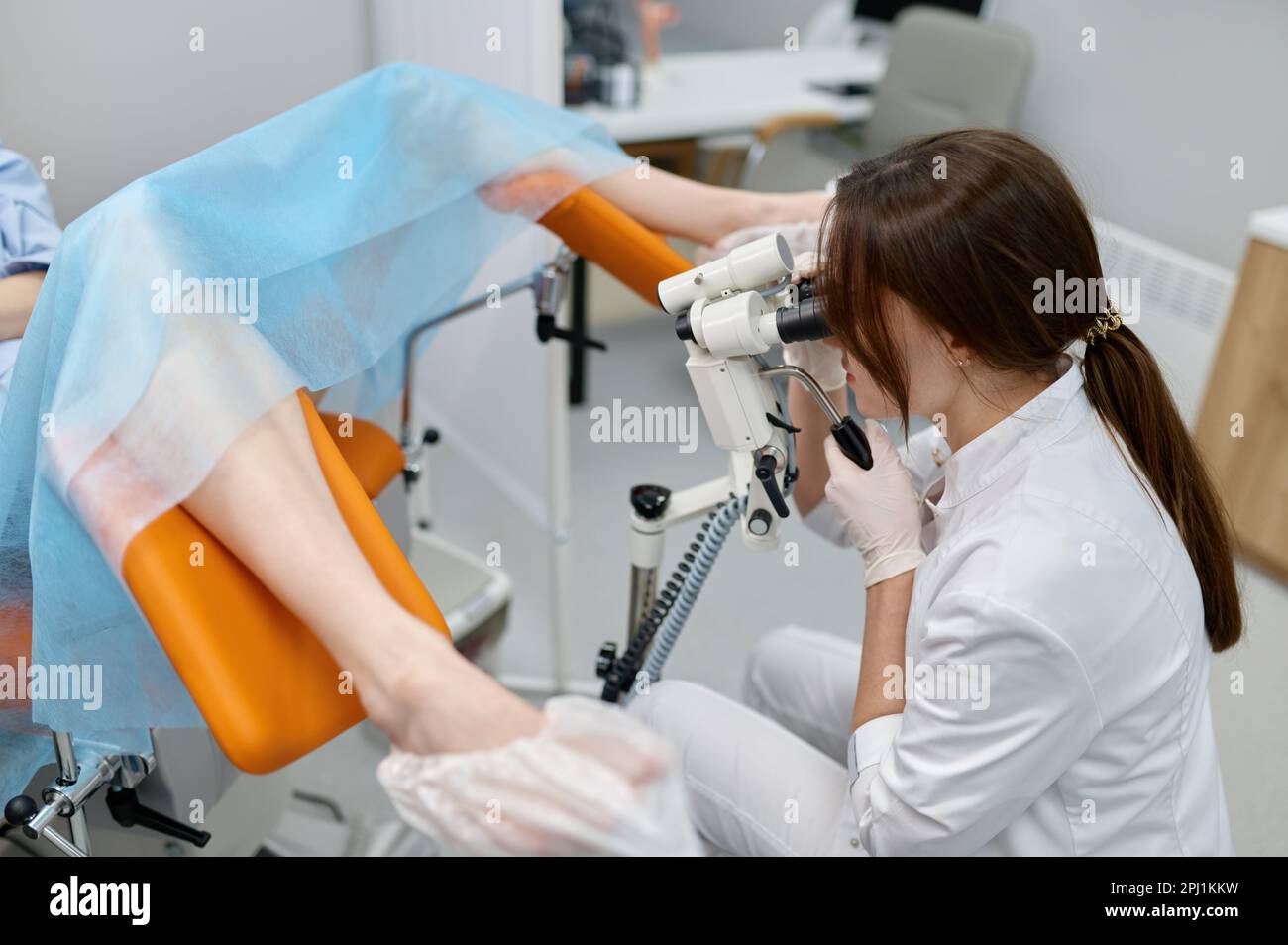 Gynecologist examining patient on chair with gynecological equipment Stock ...