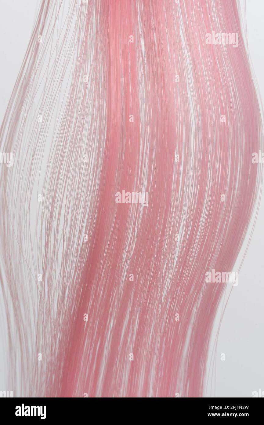 Silky smooth pink color hair background macro close up view Stock Photo