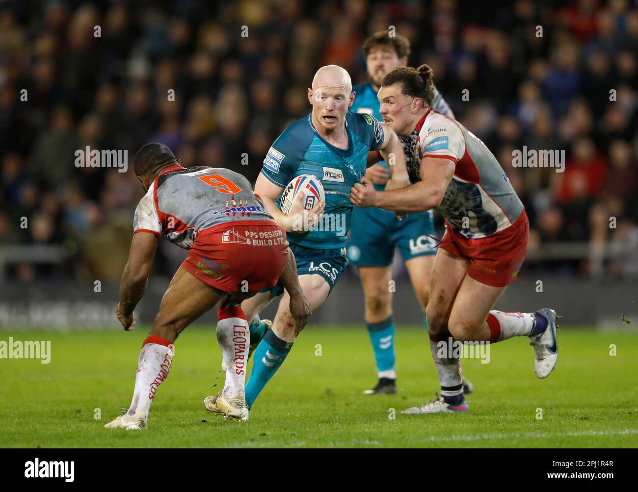 Wigan Warriors' Liam Farrell (centre) in action with Leigh Leopards ...