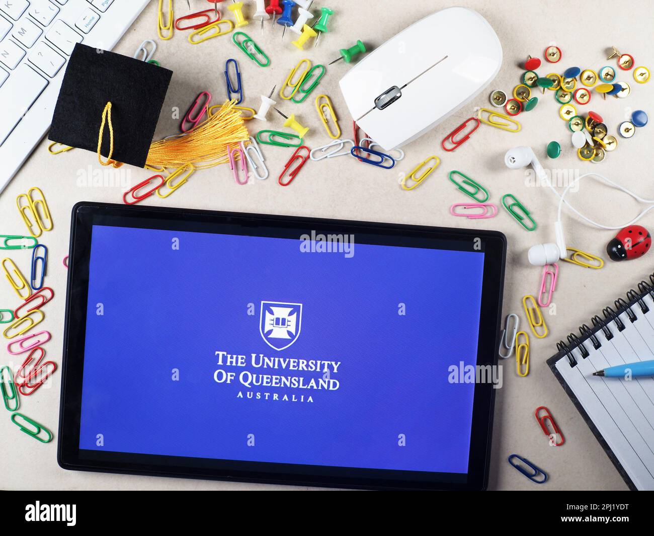 In this photo illustration, The University of Queensland logo seen displayed on a tablet. Stock Photo