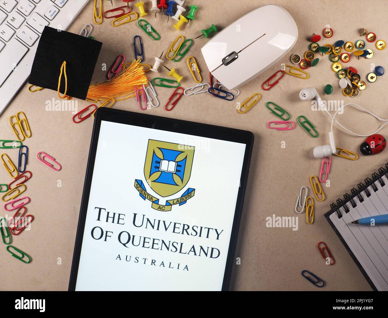 In this photo illustration, The University of Queensland logo seen displayed on a tablet. Stock Photo