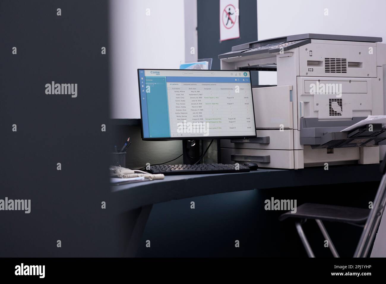 Empty health facility registration counter with medical appointments on ...