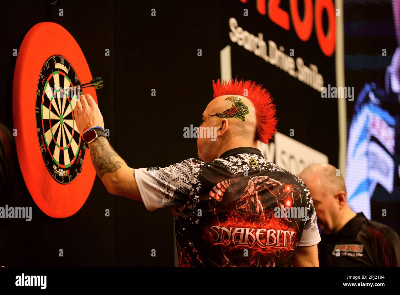 Berlin, Germany. 30th Mar, 2023. Darts: Premiere League, 9. league day in  the Mercedes-Benz Arena; Price (Wales) v Wright (Scotland). Peter Wright  removes the darts after a 180 throw. Credit: Jean-Marc Wiesner/dpa/Alamy