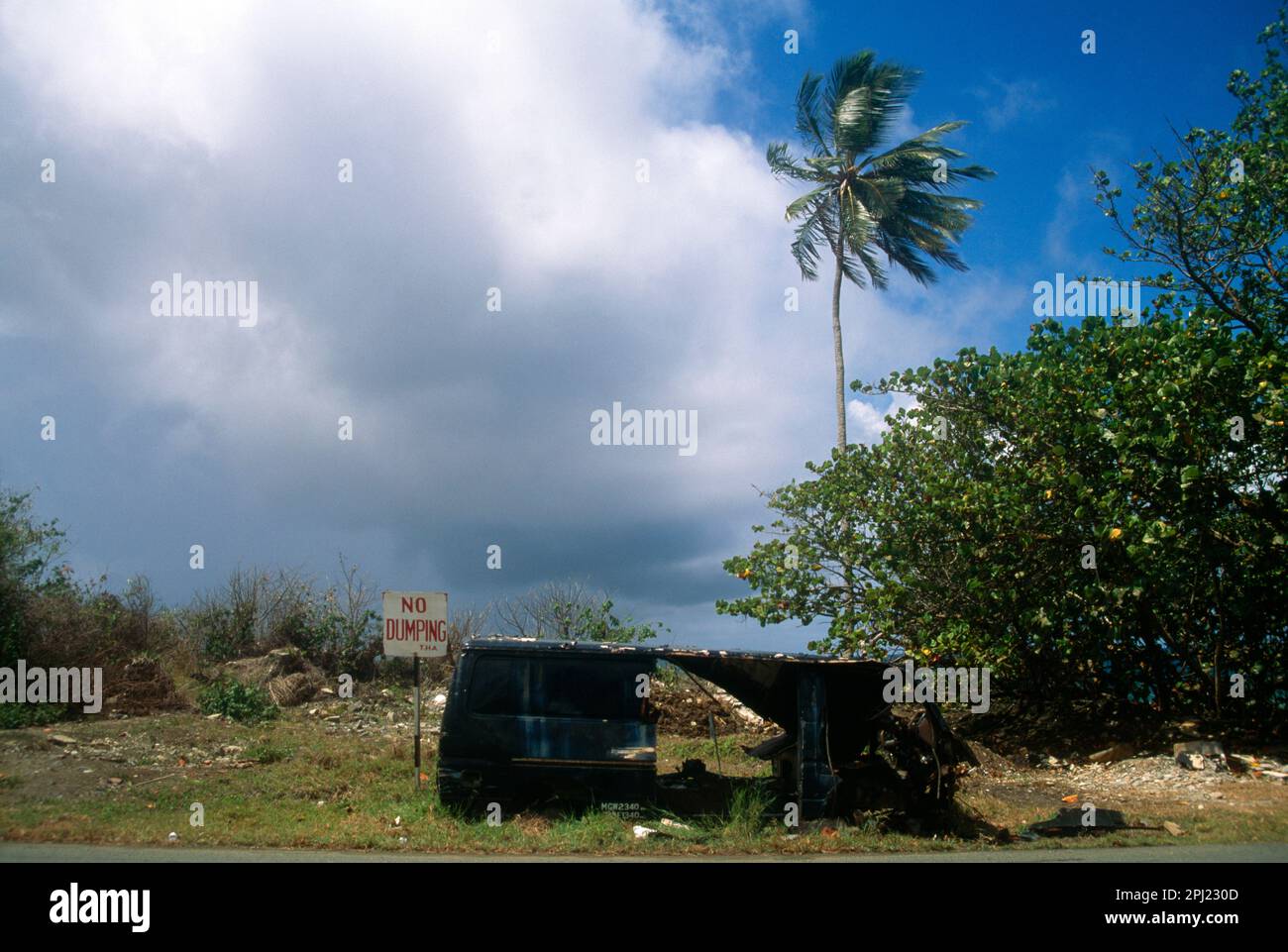 Scarborough Tobago Burnt out Vehicle Dumped by No Dumping Sign Stock Photo