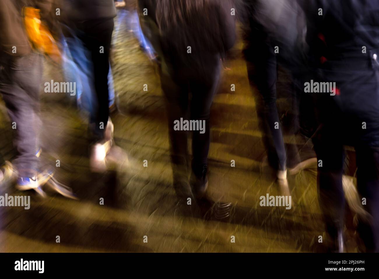 picture with camera made motion blur of a crowd of young people walking ...