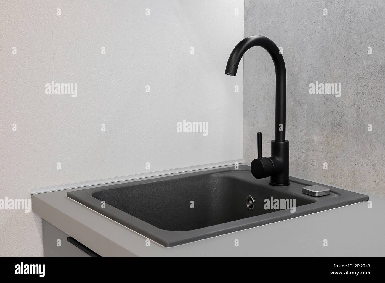 Black faucet and granite sink in the kitchen Stock Photo Alamy