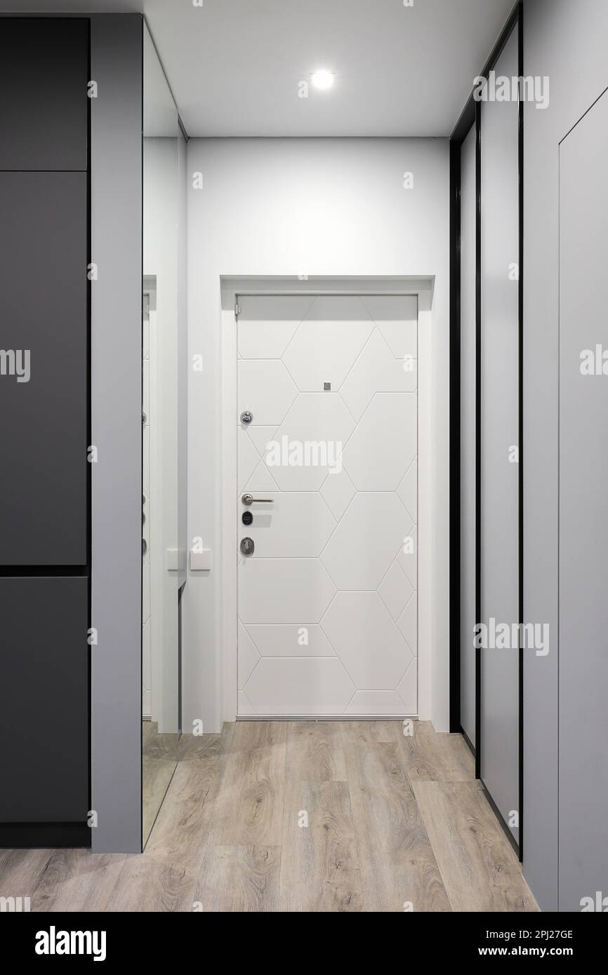 White entrance door inside an apartment building in a modern interior Stock  Photo - Alamy, image size:866x1390