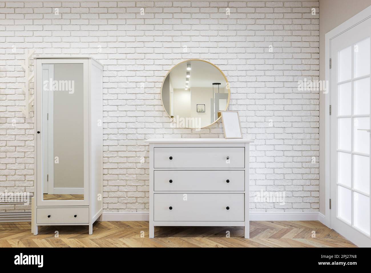 White chest of drawers with a mirror and wardrobe Stock Photo Alamy