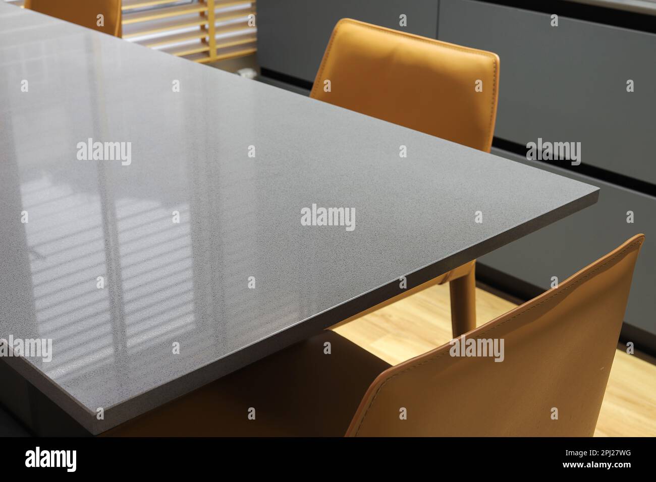 Grey quartz dining table with chairs in the kitchen Stock Photo Alamy