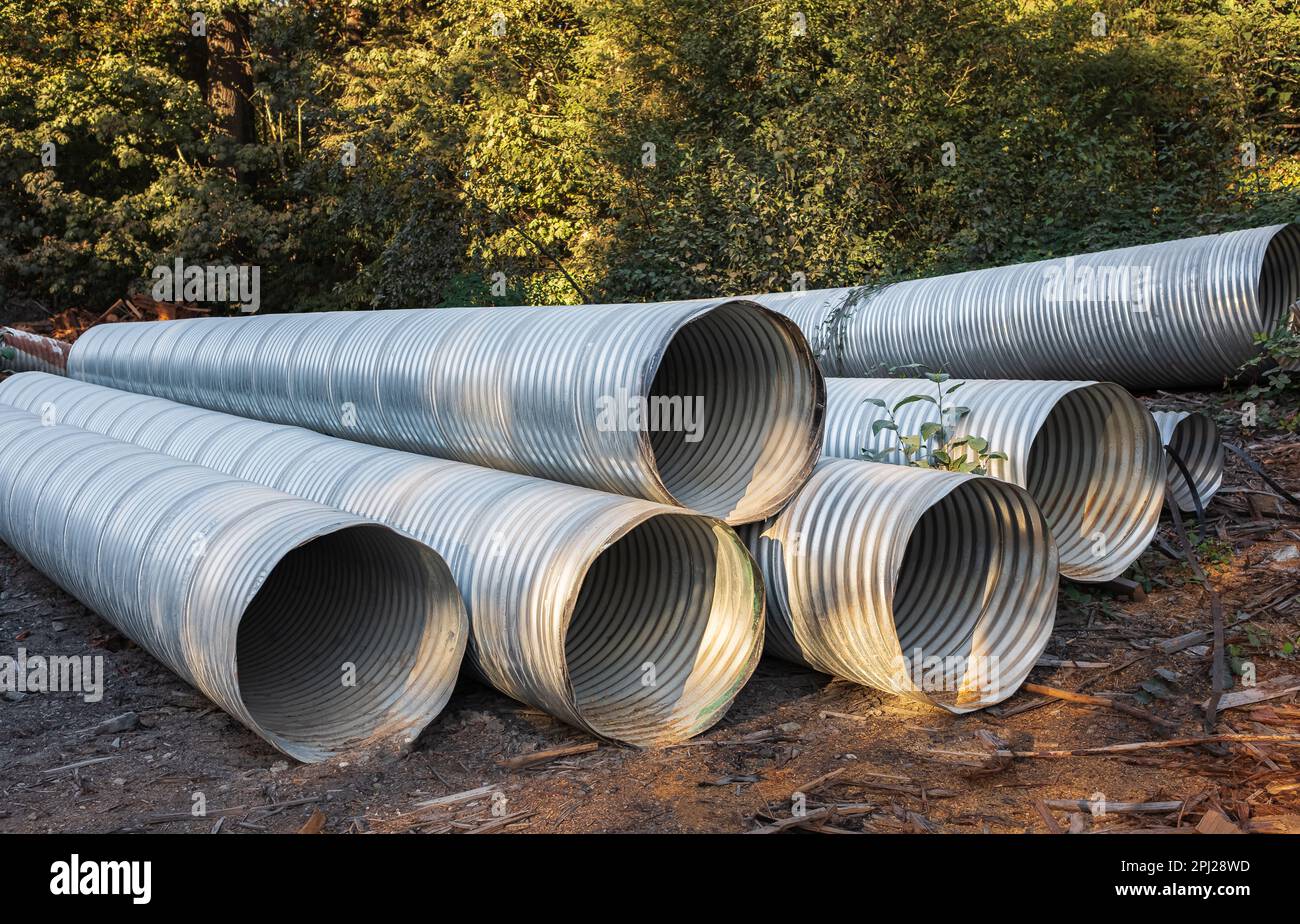 Stormwater pipes. Large Corrugated Metal Culvert Pipes in Field