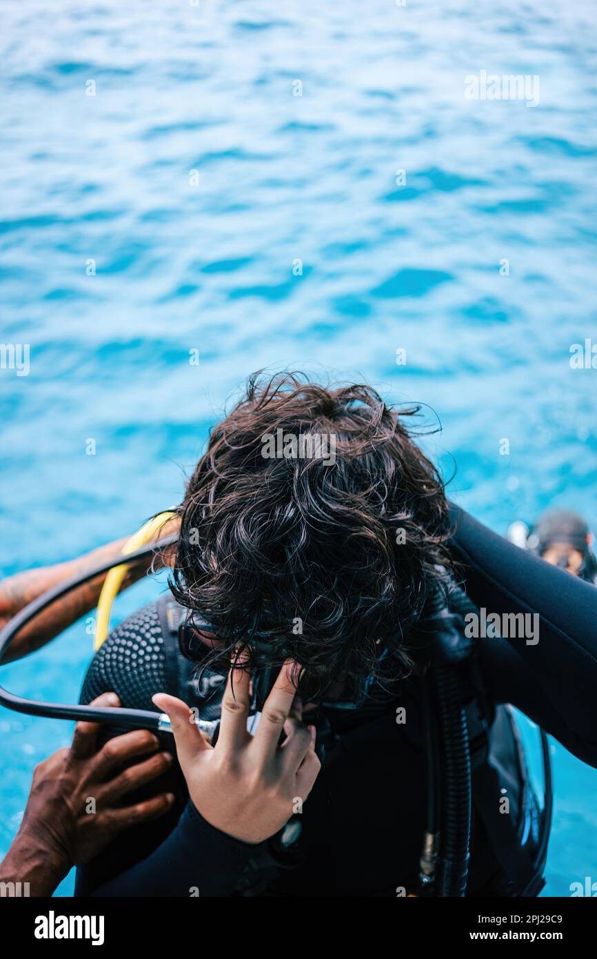 Top view of a diver ready to jump backwards from the boat into the
