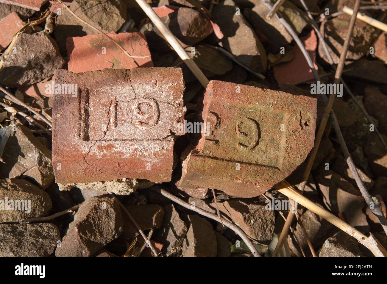 Broken brick with 1929 relief Stock Photo