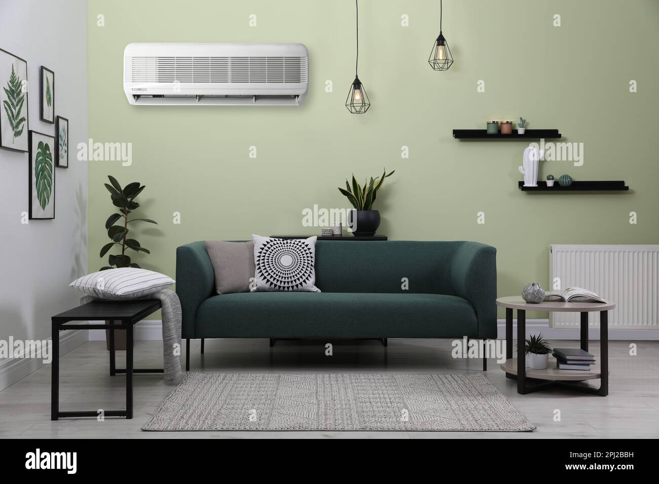 Modern air conditioner on light green wall in living room with stylish ...