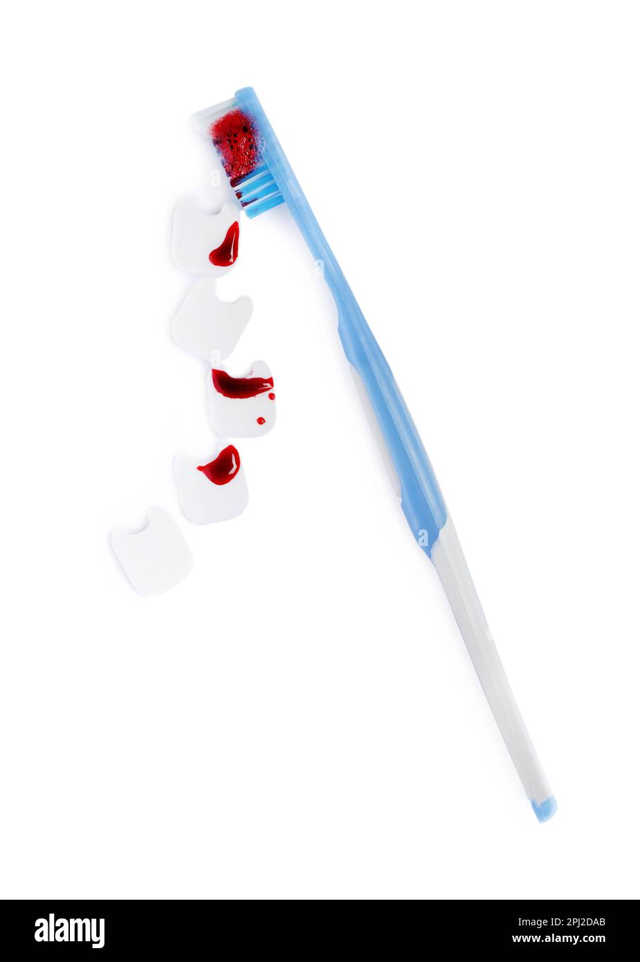 Decorative teeth and toothbrush with blood on white background, top