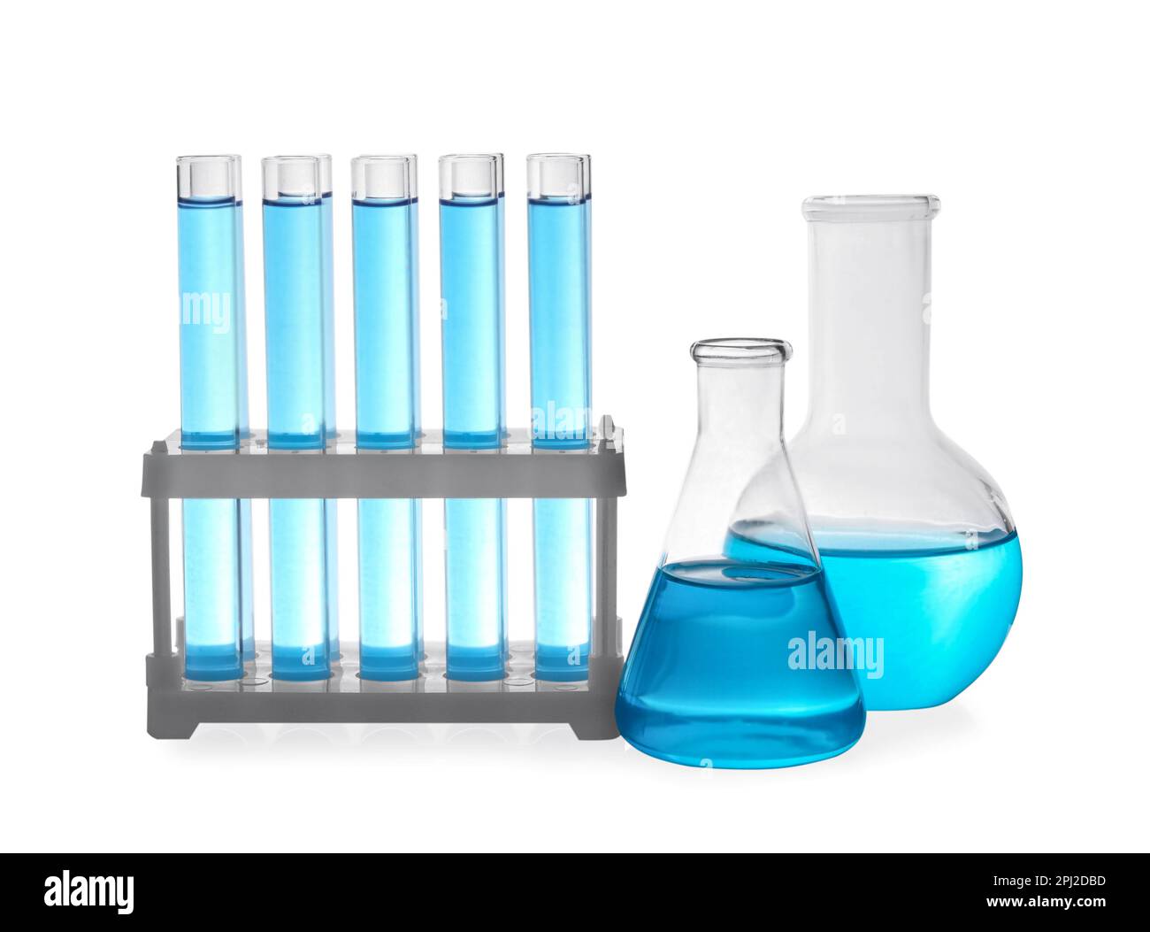 Different laboratory glassware with light blue liquid on white ...
