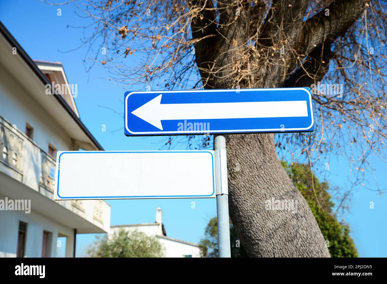 Road sign One Way Traffic and street name plate on pole outdoors Stock Photo