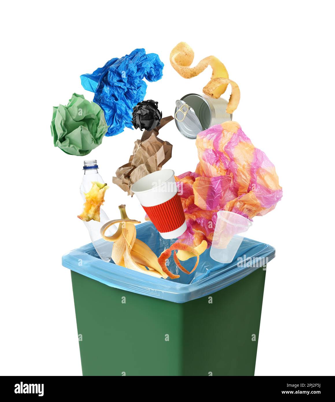 Different garbage falling into trash bin with rubbish bag on white