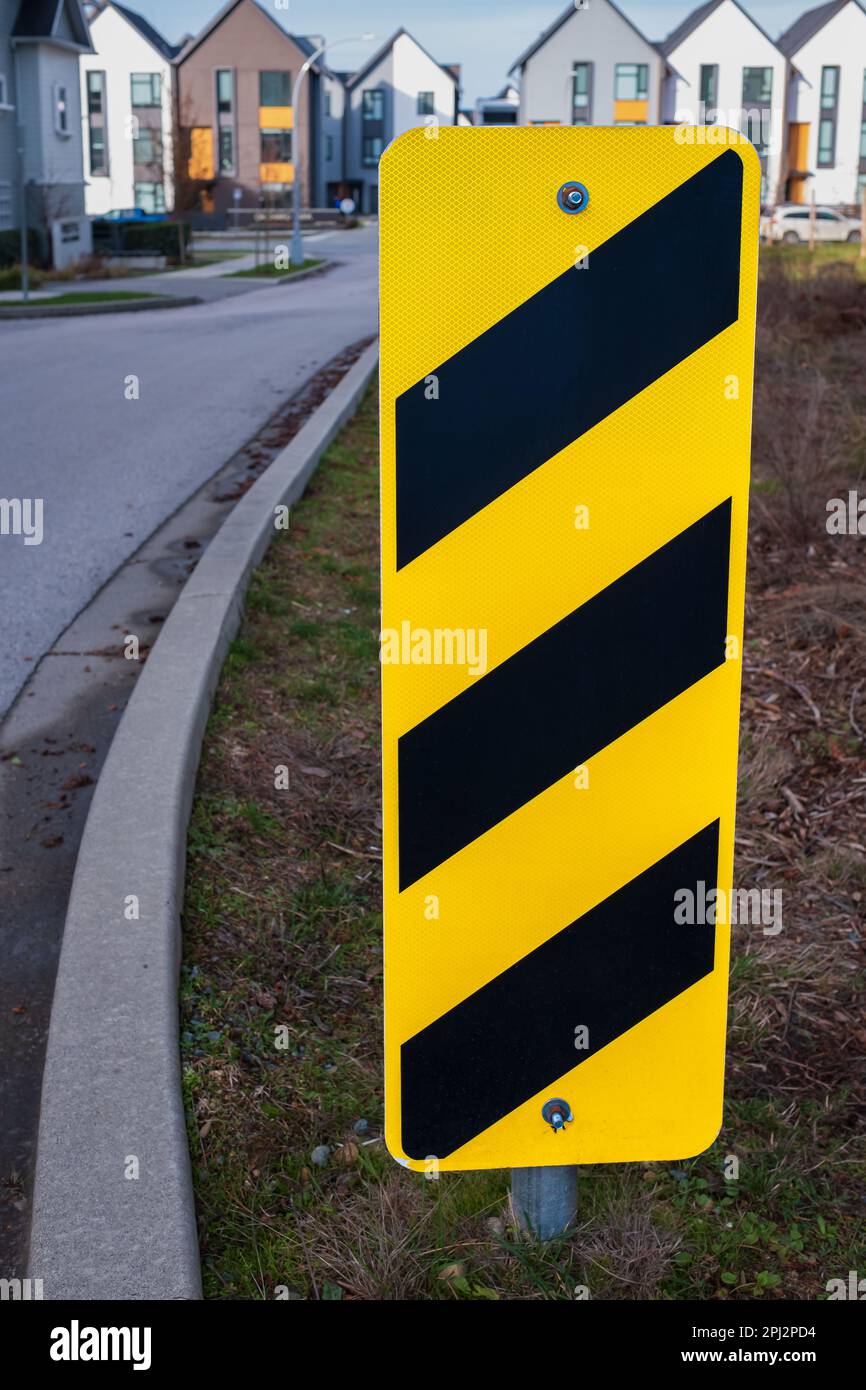 Safety sign yellow and black on an urban street. Yellow and black