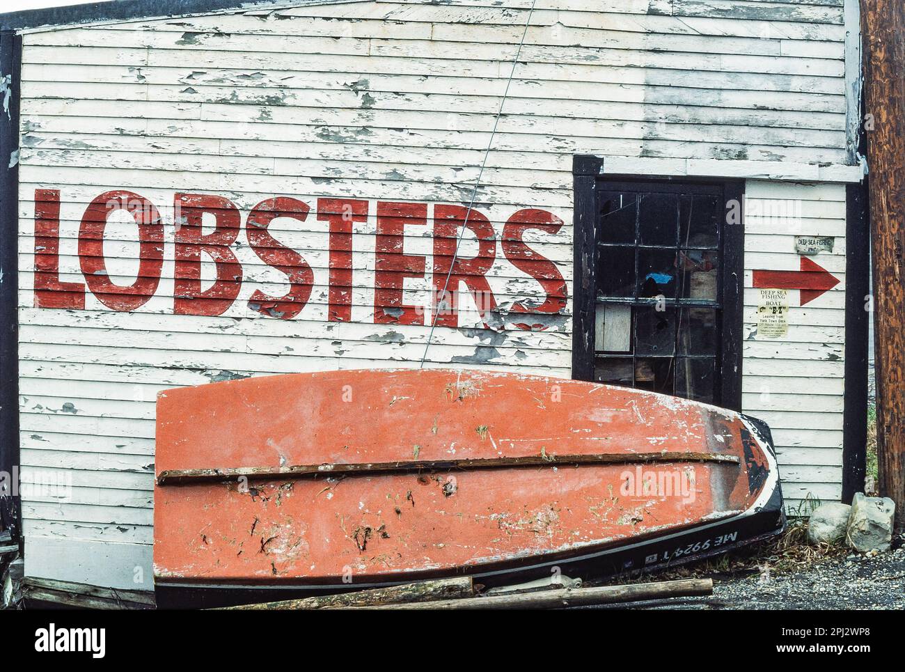 Old lobster shacks with hand painted graphics and weathered clapboard on wharf at York Harbor