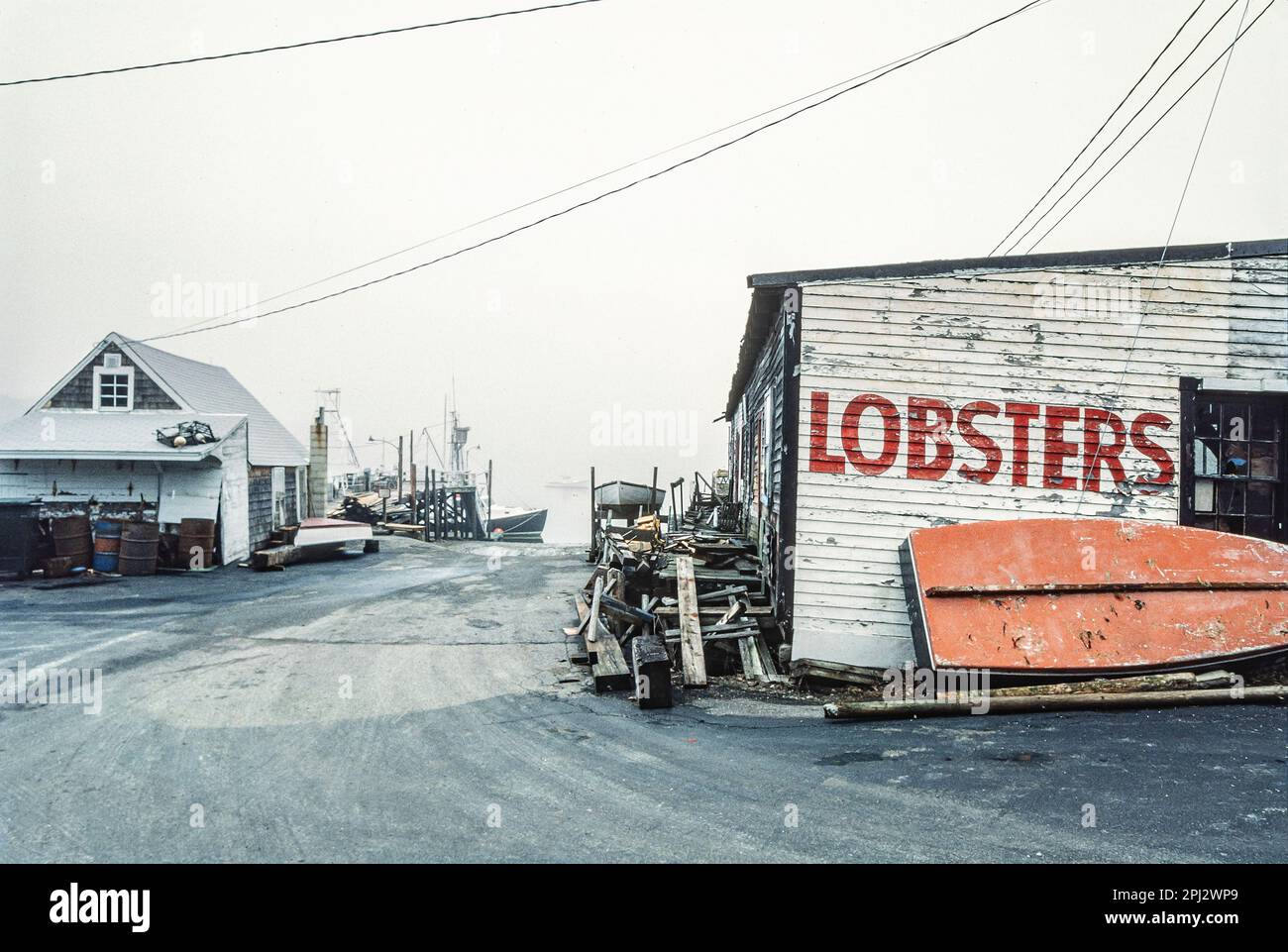 Old lobster shacks with hand painted graphics and weathered clapboard on wharf at York Harbor
