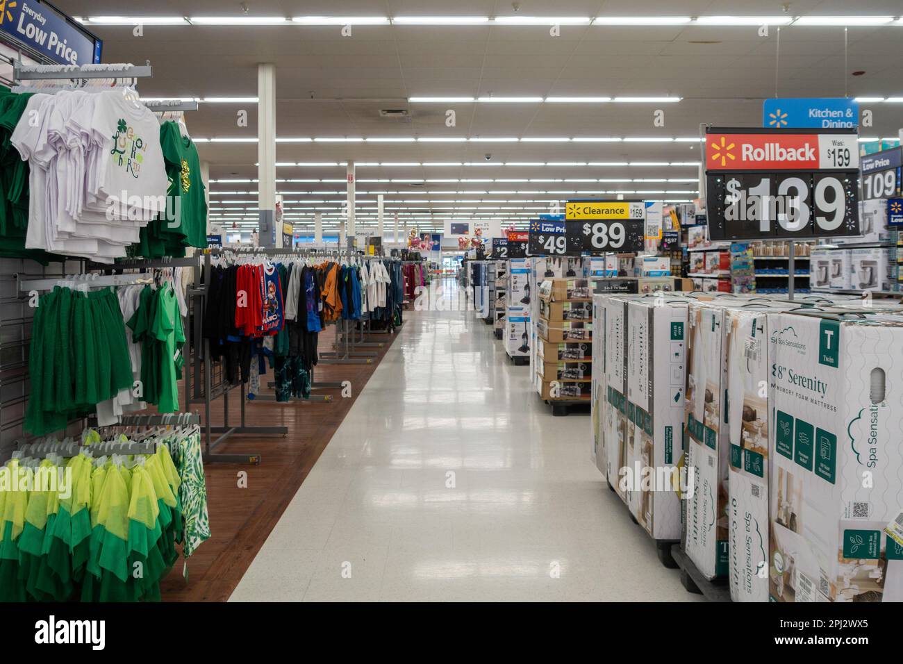 Interior of a Walmart super center showing an aisle with children’s clothing & foam mattresses. Wichita, Kansas, USA. Stock Photo